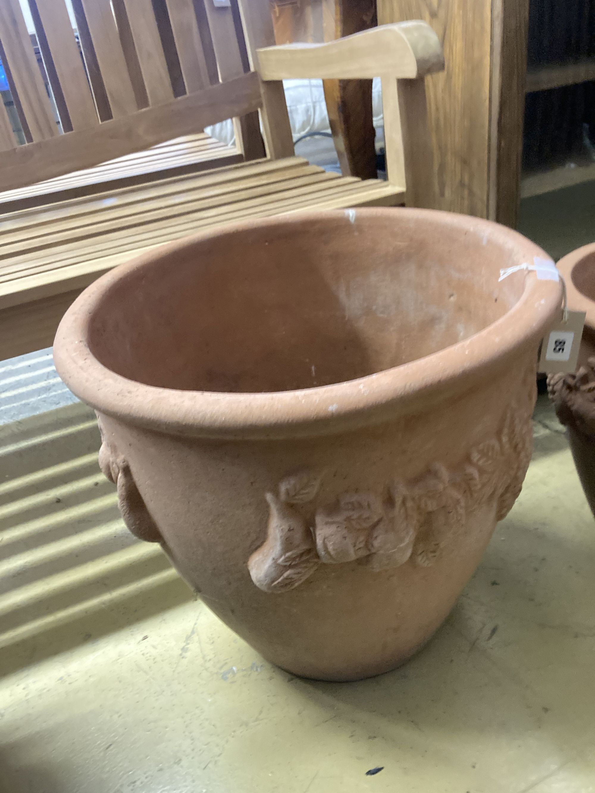 Four circular terracotta garden urns, largest 50cm diameter, 46cm high